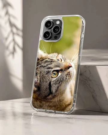 Close-up photographic print of a curious tabby cat looking upward on a phone case