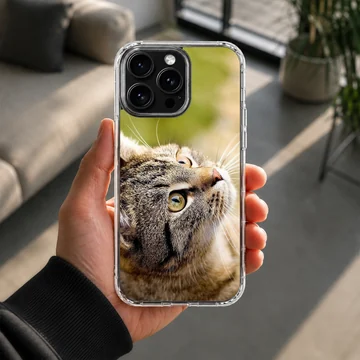 Close-up photographic print of a curious tabby cat looking upward on a phone case — Lifestyle