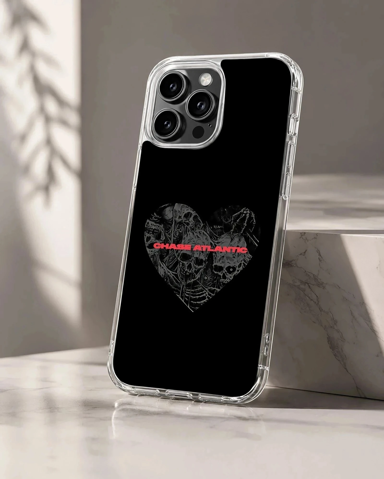 Chase Atlantic phone case featuring a dark heart graphic filled with detailed skulls and red typography