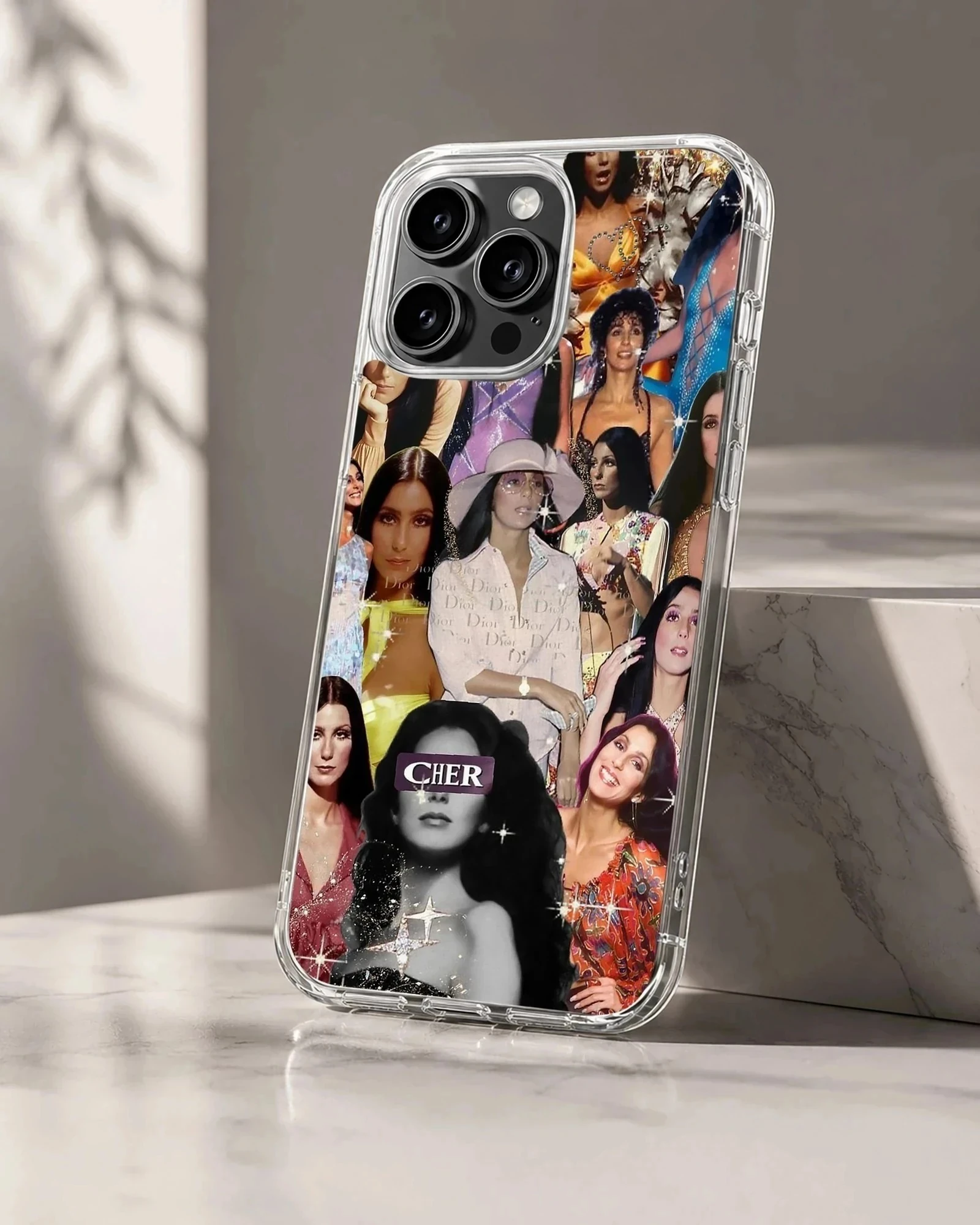 A soft TPU snap phone case showcasing a vibrant vintage collage of Cher portraits with sparkle effects.