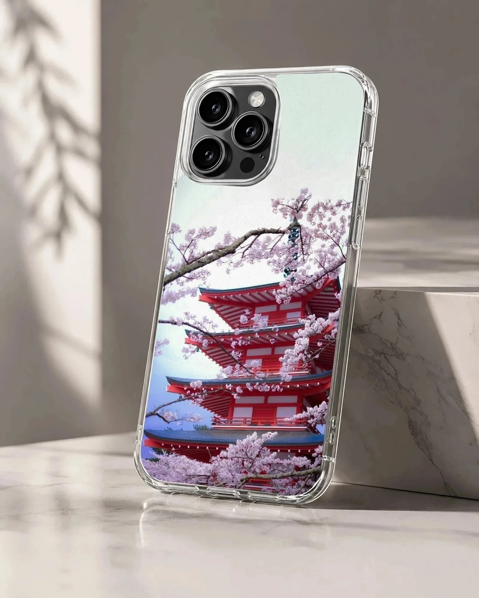 A soft TPU snap phone case featuring a photograph of a red tiered pagoda framed by blooming pink cherry blossom branches.