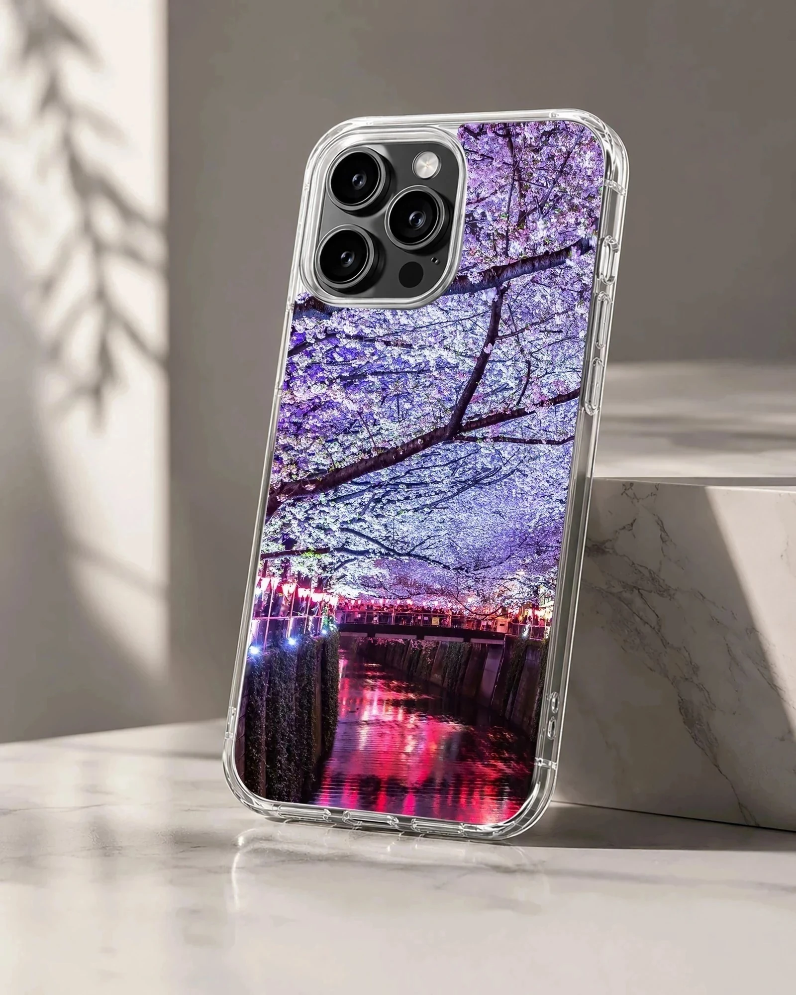 Photographic print of cherry blossoms over a glowing night river on a phone case