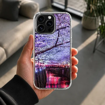 Photographic print of cherry blossoms over a glowing night river on a phone case — Lifestyle