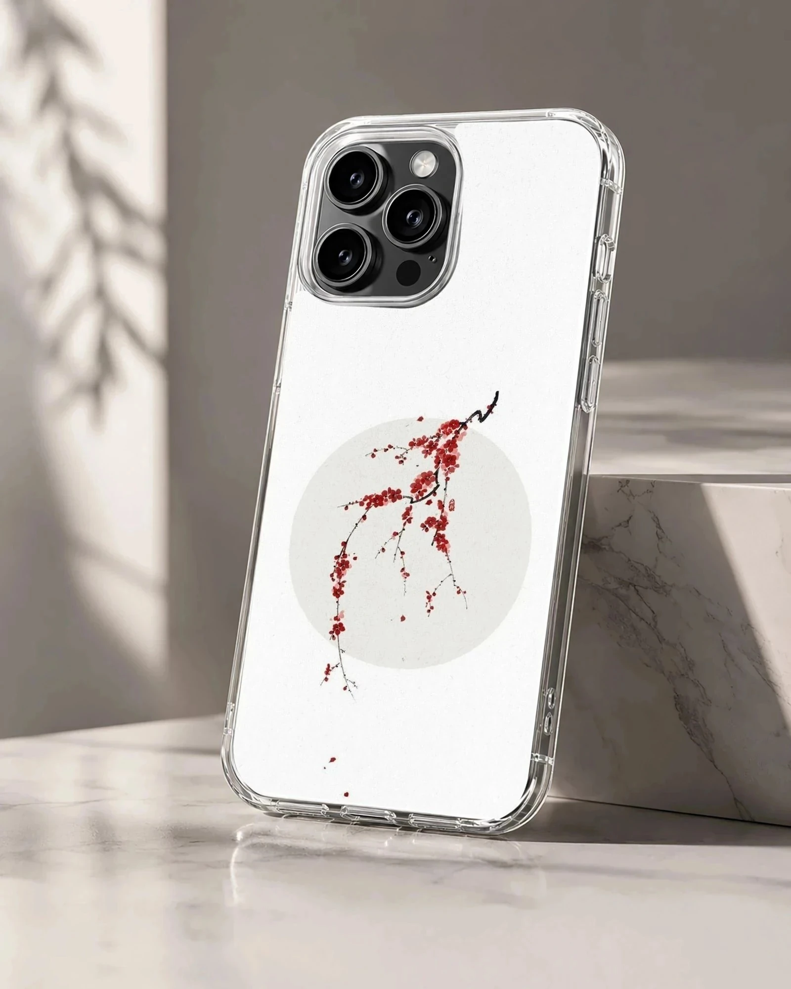 Minimalist digital illustration of a cherry blossom branch with red petals over a pale sun disc on a phone case