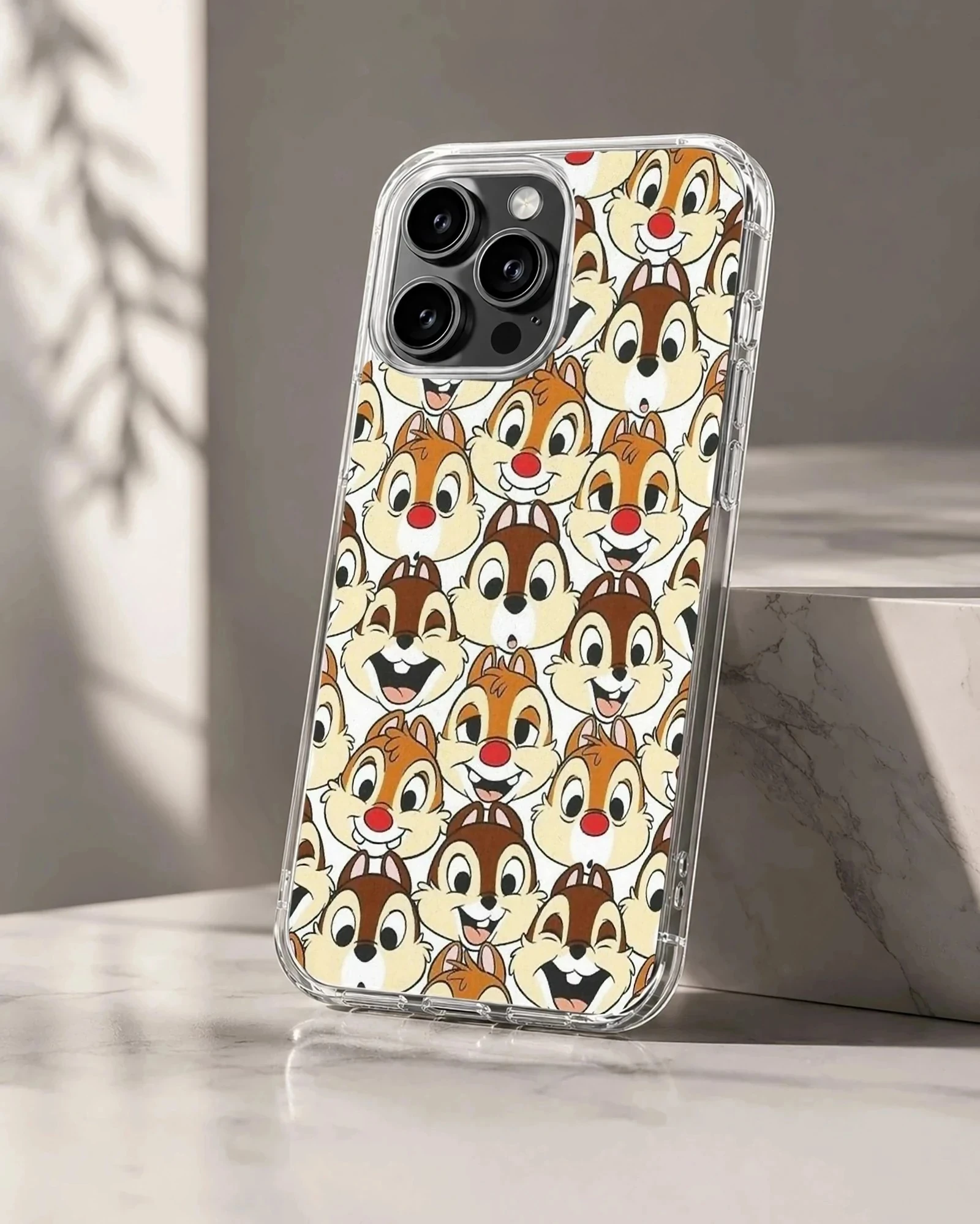 An allover pattern of classic cartoon chipmunk faces with red noses on a phone case