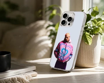 Chris Brown in a colorful pink and blue heart puffer jacket on a phone case — Lifestyle
