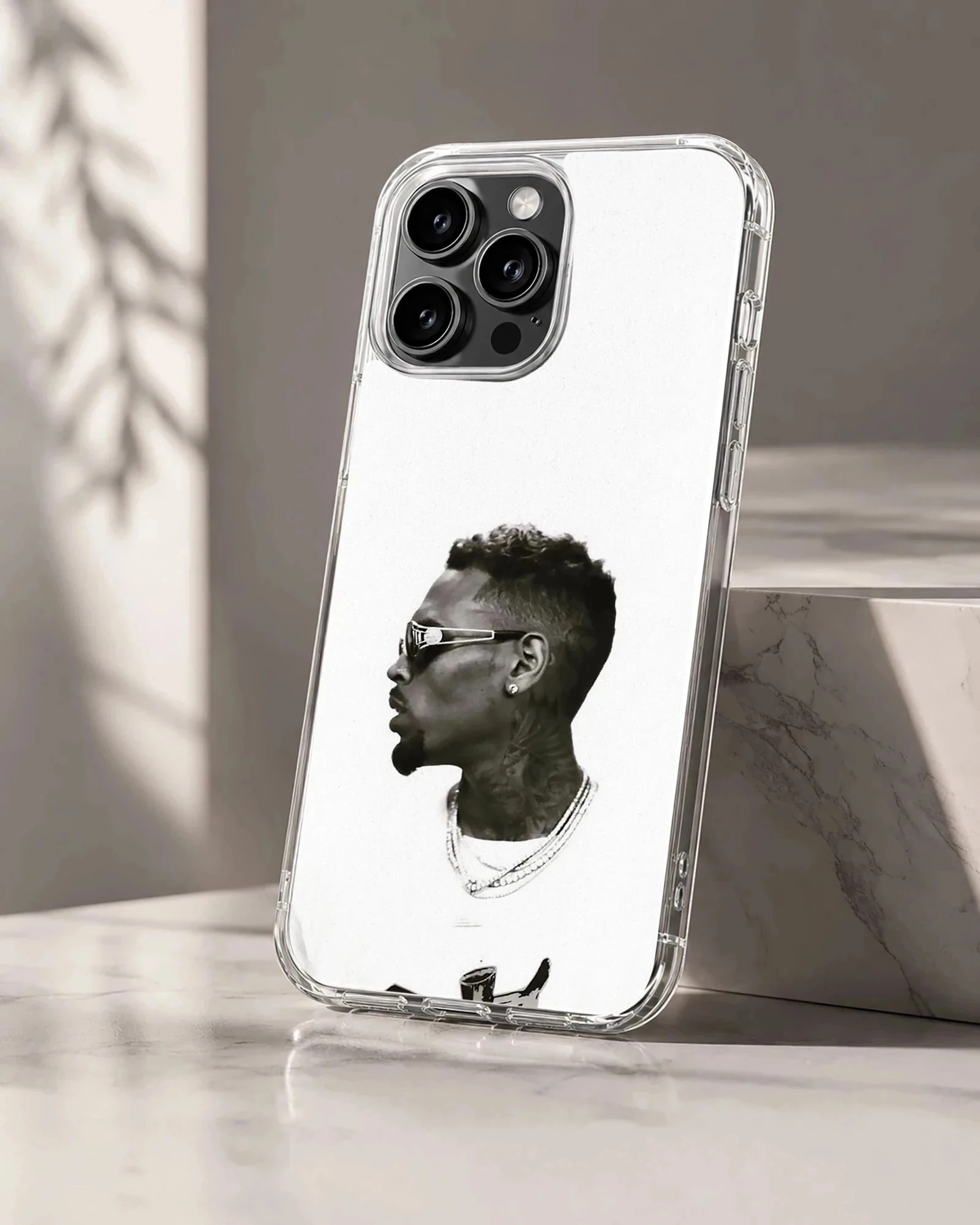 Monochrome profile portrait of a stylish man wearing sunglasses and chains on a phone case