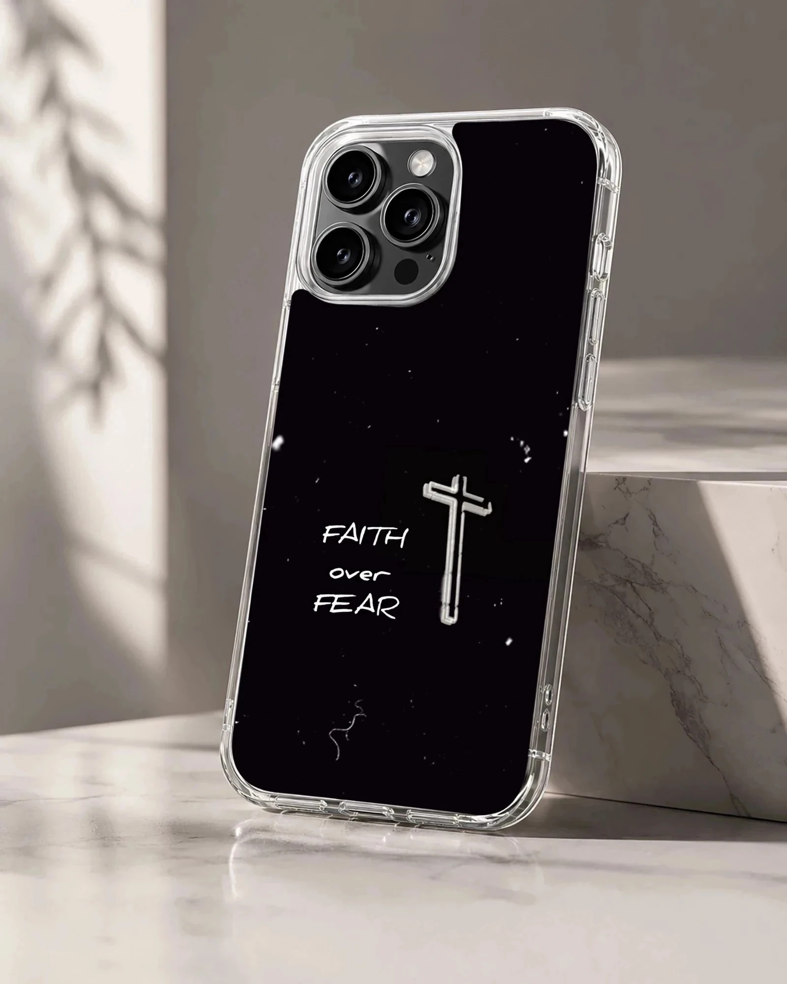 Minimalist black phone case featuring a white cross and the text faith over fear