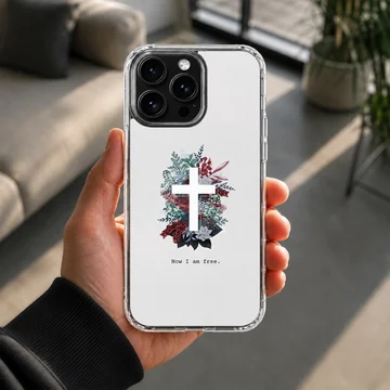 White phone case featuring a white cross centered in a lush arrangement of red, blue, and green foliage with the words Now I am free underneath. — Lifestyle
