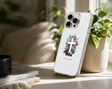 White phone case featuring a white cross centered in a lush arrangement of red, blue, and green foliage with the words Now I am free underneath. — Lifestyle