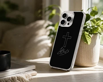 A black snap case featuring a clean white Christian cross graphic and cursive text, shown as a phone case — Lifestyle