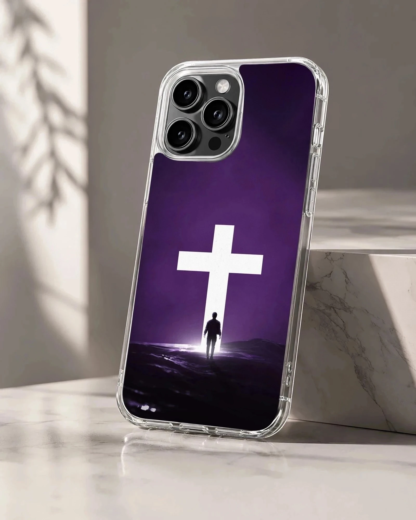 A digital illustration of a solitary figure standing before a glowing white cross against a dark purple background on a phone case
