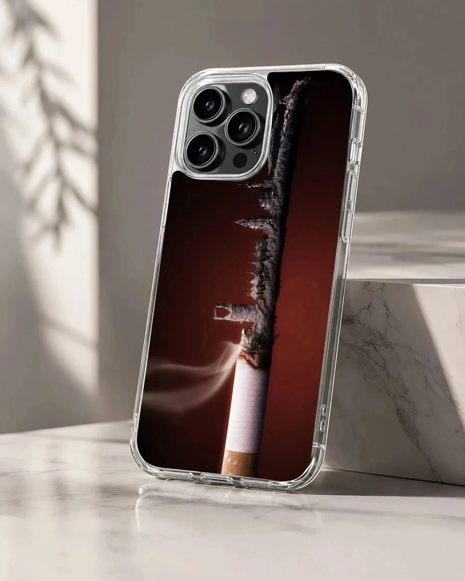 Close-up photographic print of a burning cigarette against a dark red background on a phone case