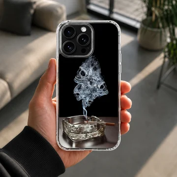 A dark phone case design featuring wisps of smoke forming skulls rising from an ashtray phone case — Lifestyle