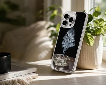 A dark phone case design featuring wisps of smoke forming skulls rising from an ashtray phone case — Lifestyle