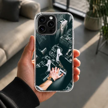 City View rooftop perspective showing sneakers dangling over a tall skyscraper drop, phone case — Lifestyle