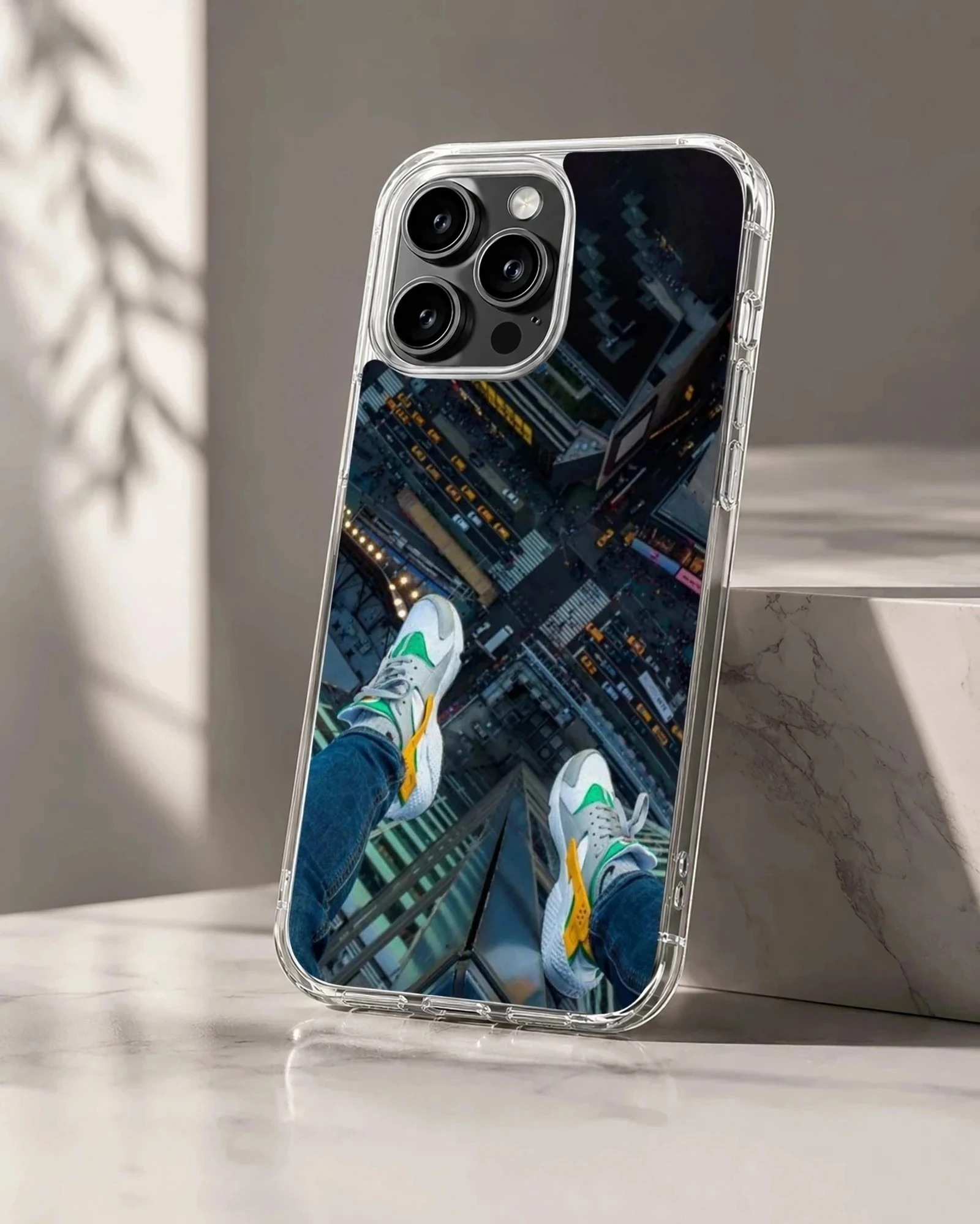 Overhead view of sneakers dangling above a city street on a phone case