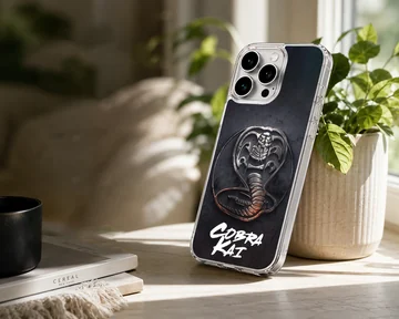 Cobra Kai phone case featuring a textured metallic snake emblem and bold white script over a dark background — Lifestyle