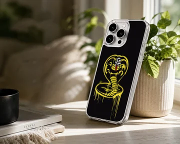 Cobra Kai yellow spray-painted snake emblem artwork on a black background phone case — Lifestyle
