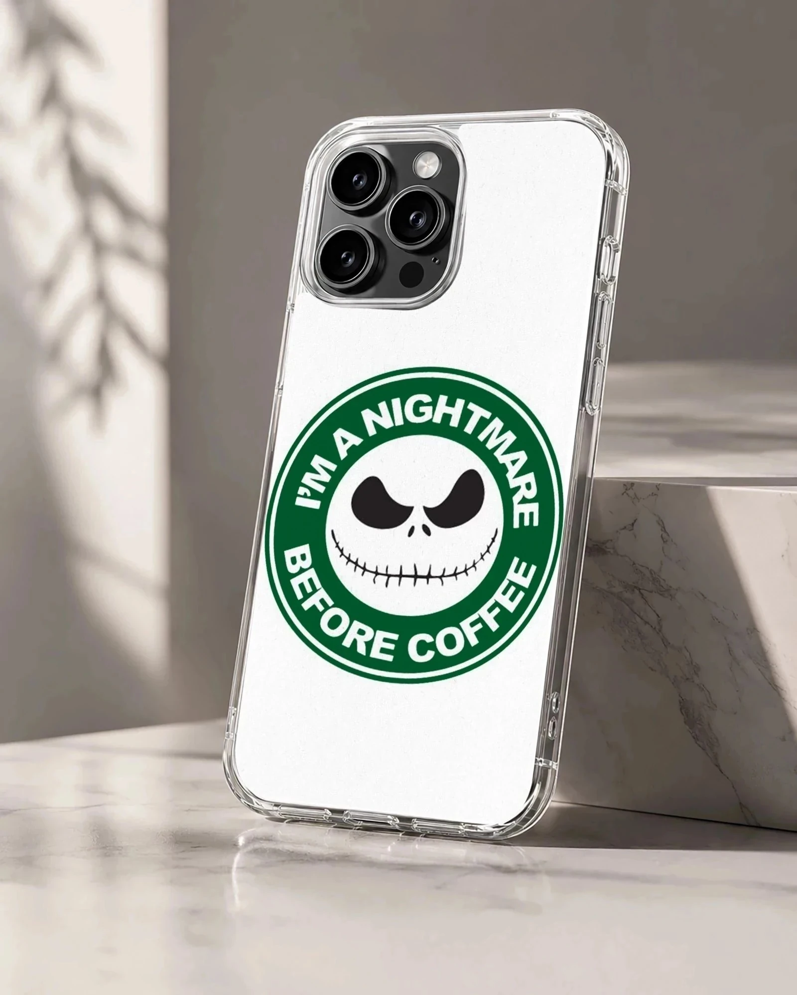 A white and green circular coffee skeleton graphic printed on a phone case