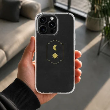 Celestial gold moon and sun emblem on a matte black phone case — Lifestyle