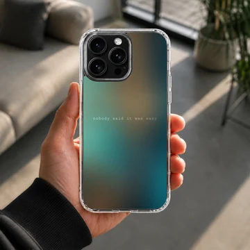 A soft TPU snap case with a blurred teal and amber gradient background and minimalist quote text phone case — Lifestyle