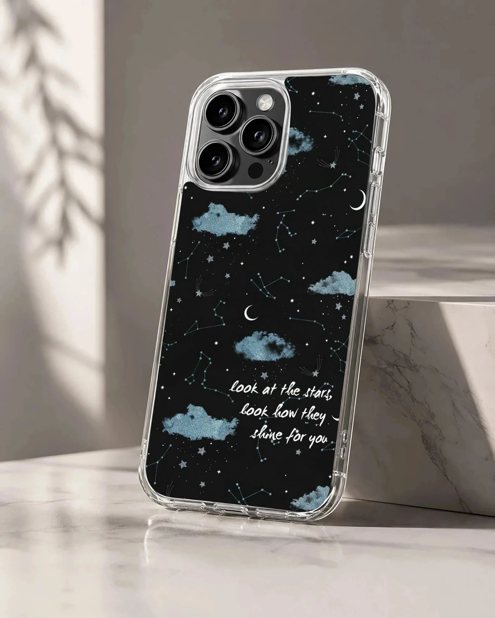 A celestial phone case featuring starry night skies, blue clouds, and handwritten song lyrics on a black background