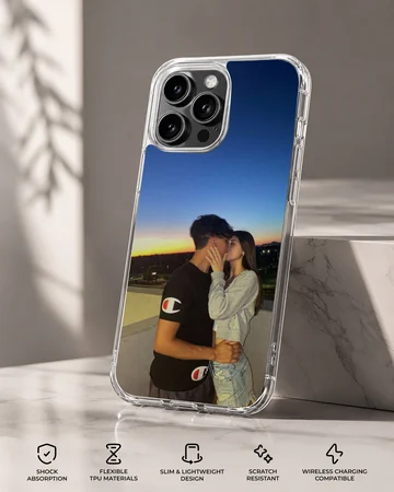 Photographic print of a young couple kissing against a vibrant sunset sky on a snap phone case. — Specs