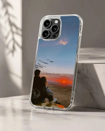 Silhouette of a couple sitting together watching a vibrant orange sunset on a romantic phone case.