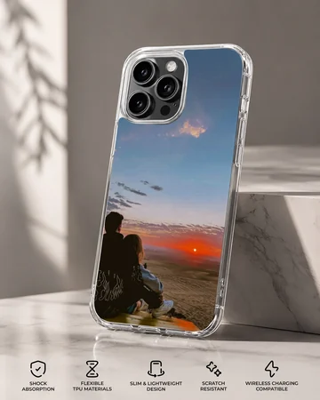 Silhouette of a couple sitting together watching a vibrant orange sunset on a romantic phone case. — Specs