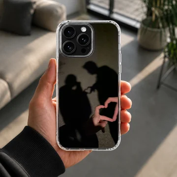 A photographic print of a couple's shadow forming a heart shape, featured on a matte phone case. — Lifestyle