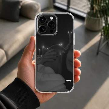Black and white photographic print of a couple embracing at night with three small white hearts on a phone case. — Lifestyle