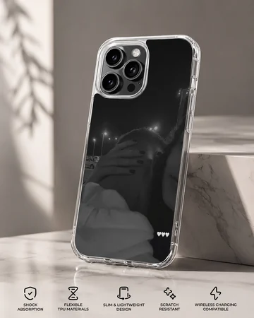 Black and white photographic print of a couple embracing at night with three small white hearts on a phone case. — Specs