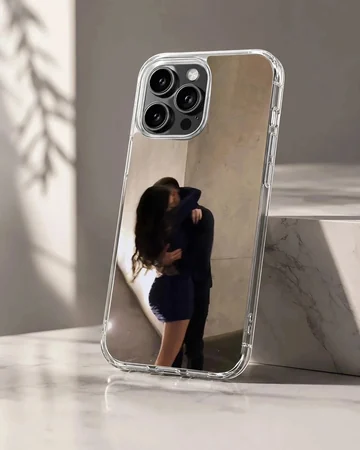 Photographic print of a couple embracing intimately against a warm neutral wall on a protective phone case.