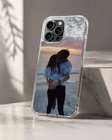 Photographic print of a young couple kissing on a beach at sunset, featured on a matte-finish phone case