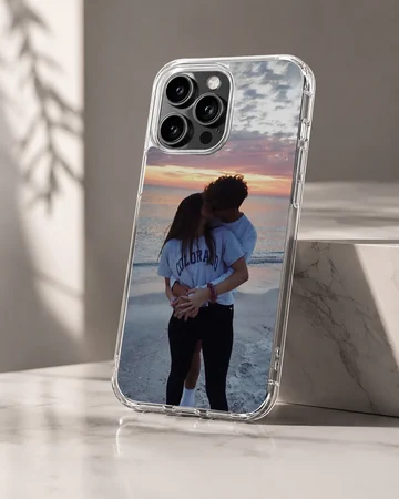 Photographic print of a young couple kissing on a beach at sunset, featured on a matte-finish phone case — Hero