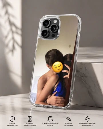 A photograph print on a phone case depicting an embracing couple taking a mirror selfie with a yellow emoji face. — Specs