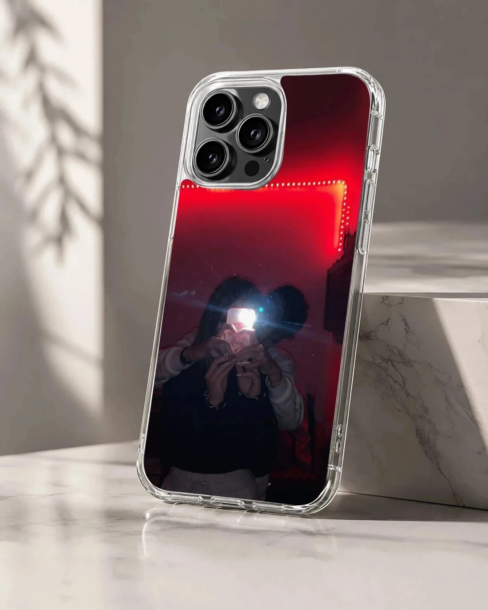 A couple taking a mirror selfie under glowing red LED lights, printed on a protective phone case