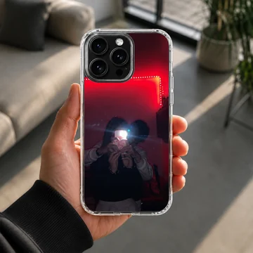A couple taking a mirror selfie under glowing red LED lights, printed on a protective phone case — Lifestyle