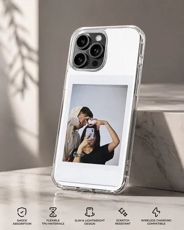 Polaroid-style photo print of a couple making a hand heart during a mirror selfie on a clear phone case. — Specs