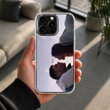 Serene couple sharing a moment with the word love on a phone case — Lifestyle
