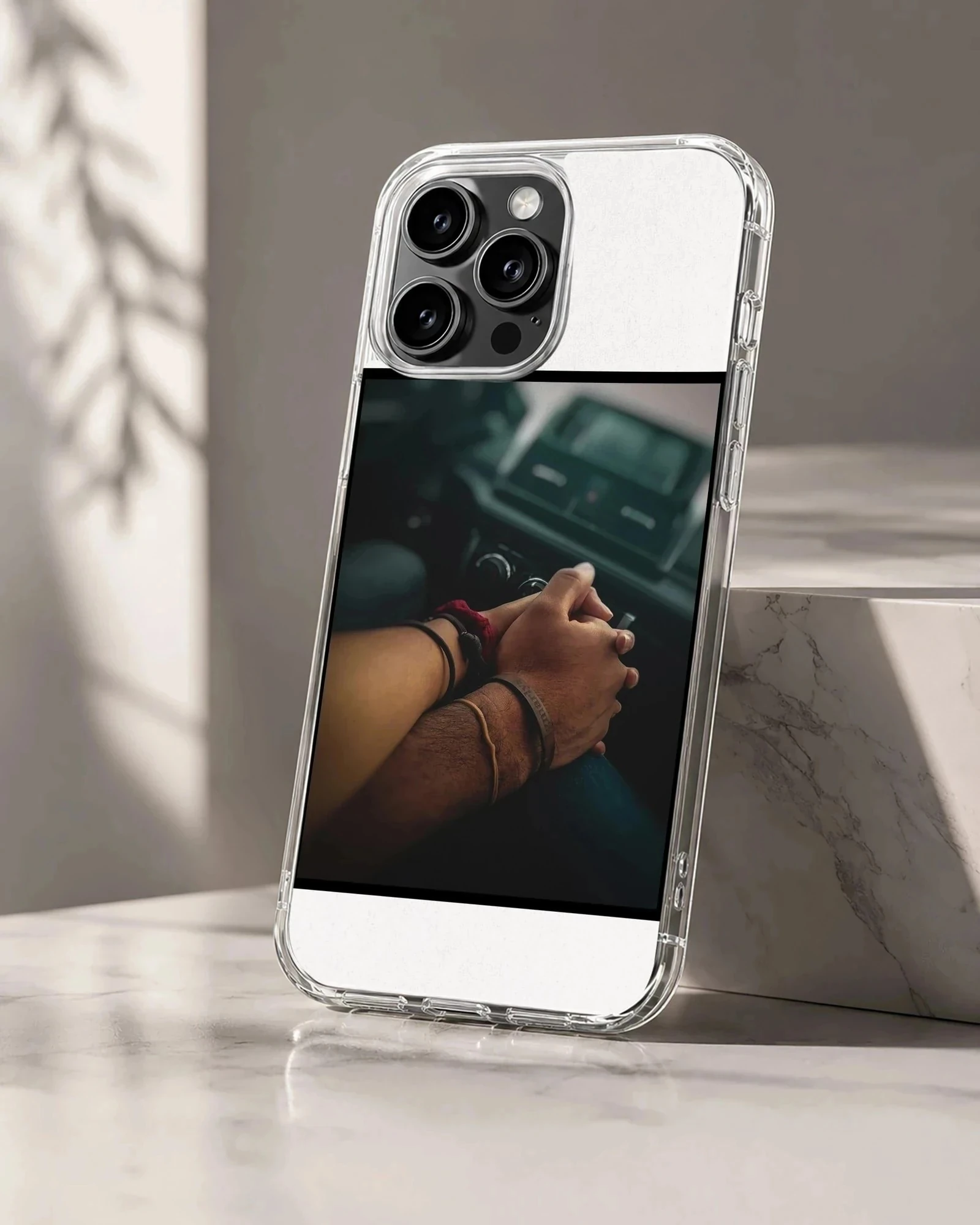 Close up photograph of a couple holding hands in a car printed on a sleek phone case