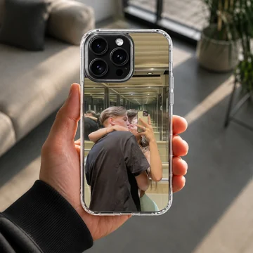 Photographic print of a young couple kissing while taking a mirror selfie in an elevator on a custom phone case — Lifestyle