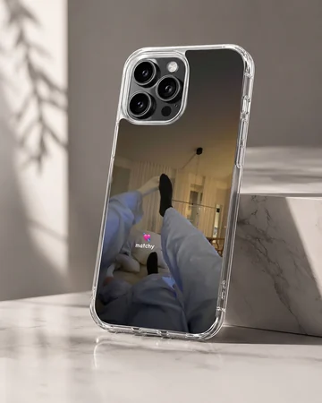Photographic print of a cozy couple lounging together in matching outfits with a matchy text overlay on a phone case — Hero