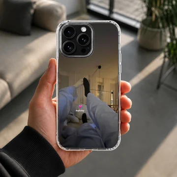 Photographic print of a cozy couple lounging together in matching outfits with a matchy text overlay on a phone case — Lifestyle