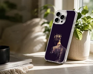 Artwork of a tailored figure wearing a glowing golden crown viewed from behind printed on a phone case — Lifestyle