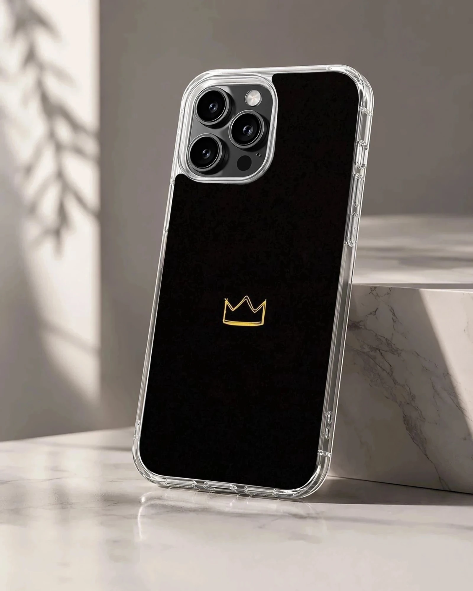Elegant black phone case featuring a minimalist golden crown design
