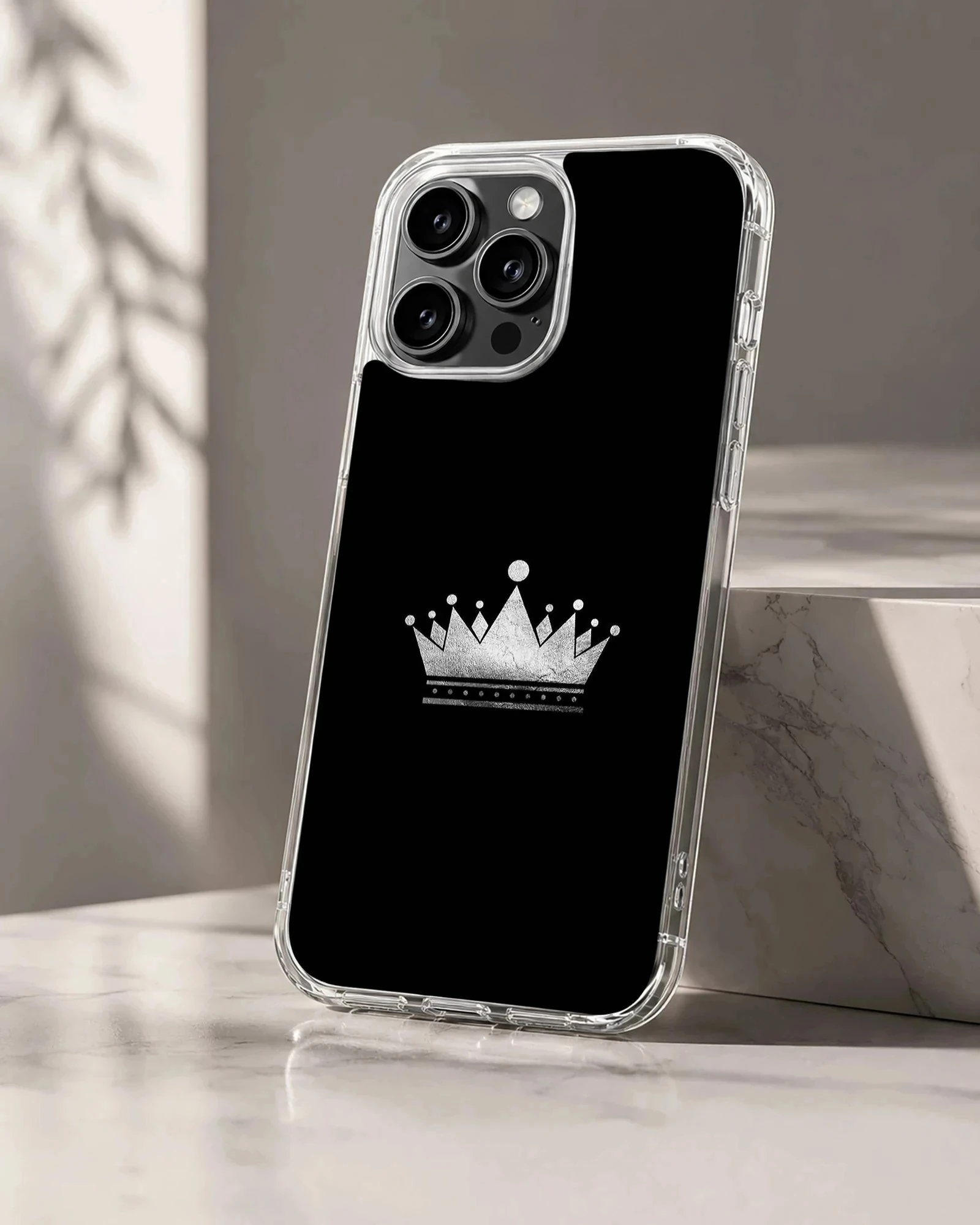 Minimalist crown design in silver on a black phone case