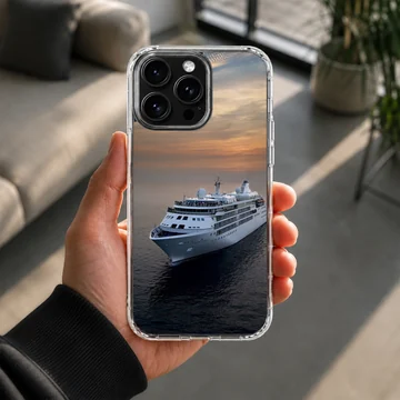 A white cruise ship sailing across dark ocean waters beneath a warm sunset sky on a phone case. — Lifestyle