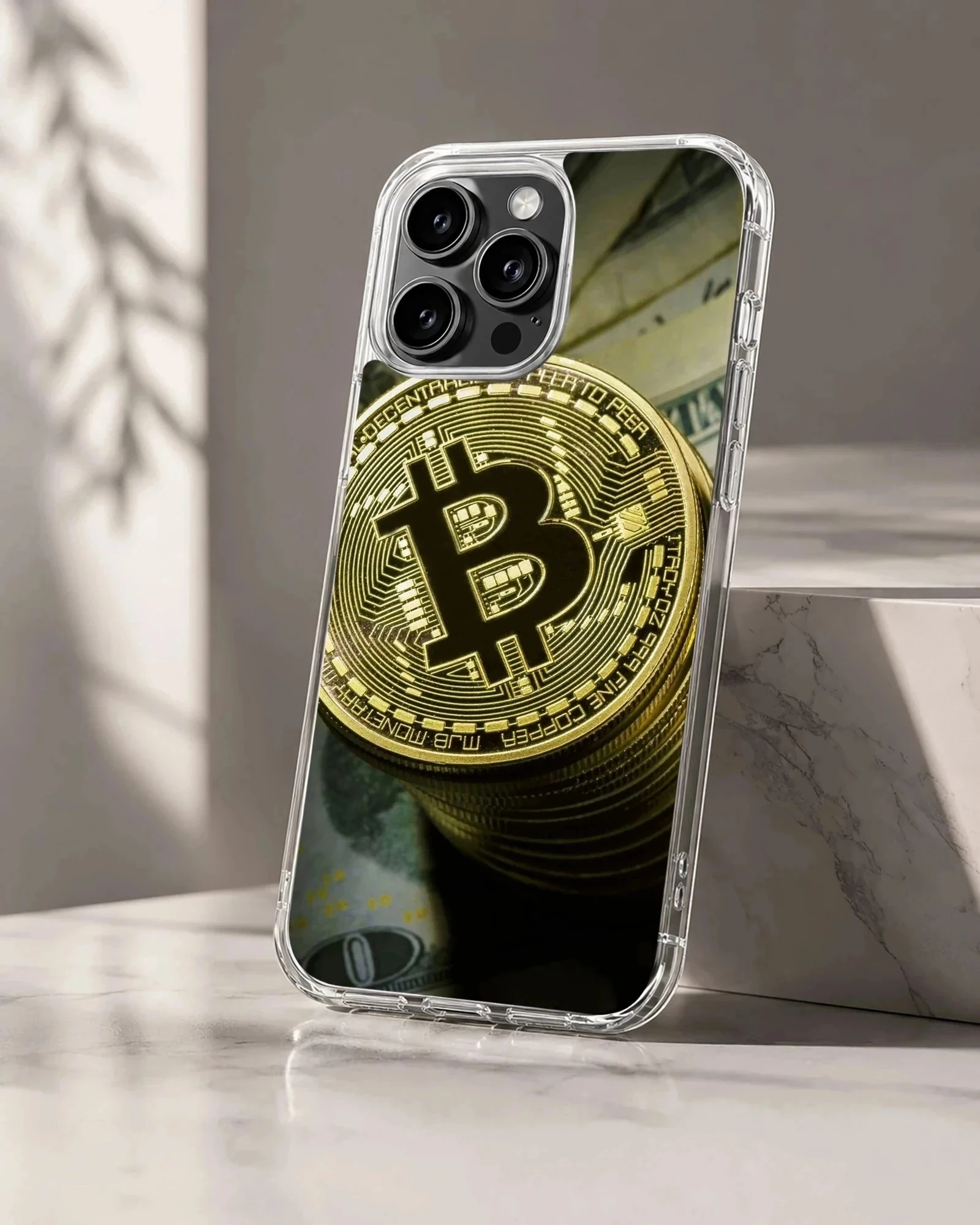 Gold Bitcoin coins stacked with currency notes on a phone case